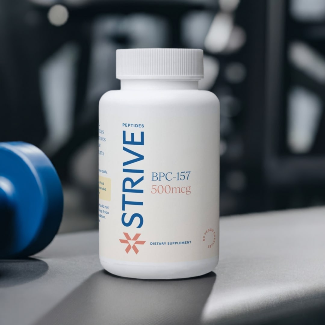 A white bottle of Strive Peptides brand BPC-157 peptides in a gym setting, on a weight bench.